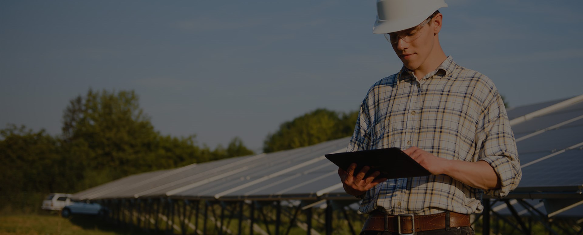 Engineer Holding Digital Tablet Working in Solar Panels Power Farm